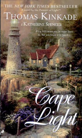 The image shows the cover of Cape Light by Thomas Kinkade & Katherine Spencer. There is cottage next to a lighthouse. There is a garden surrounding with many colorful flowers. 