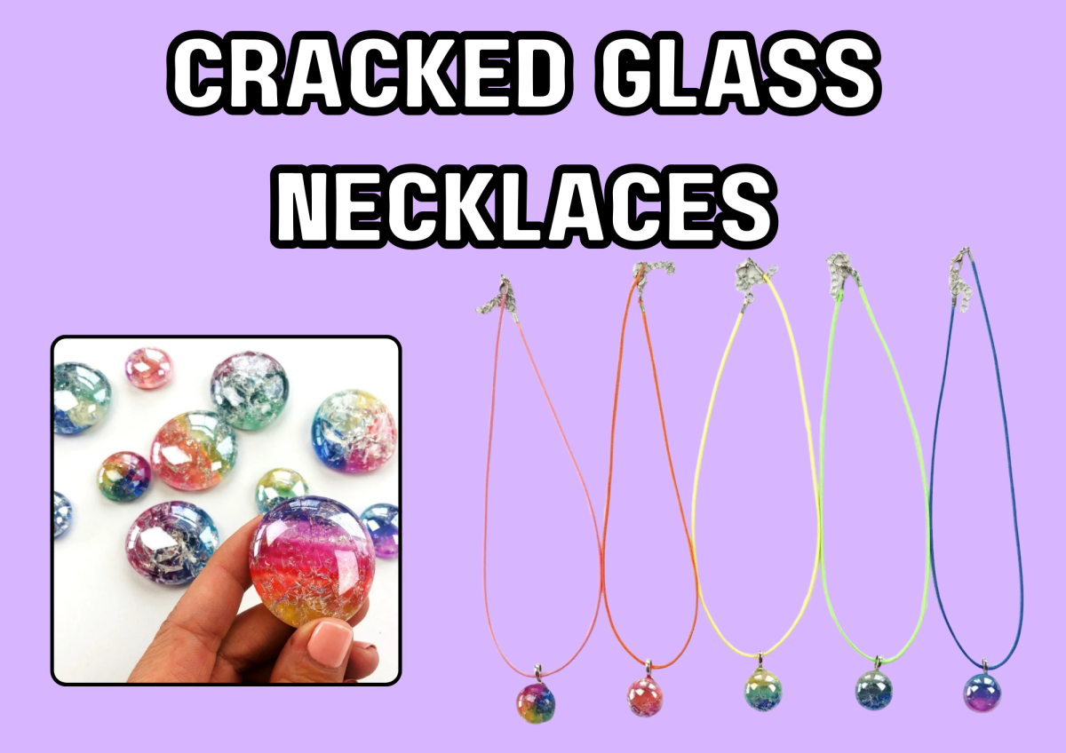 Cracked glass necklaces displayed with colorful pendants and strings.